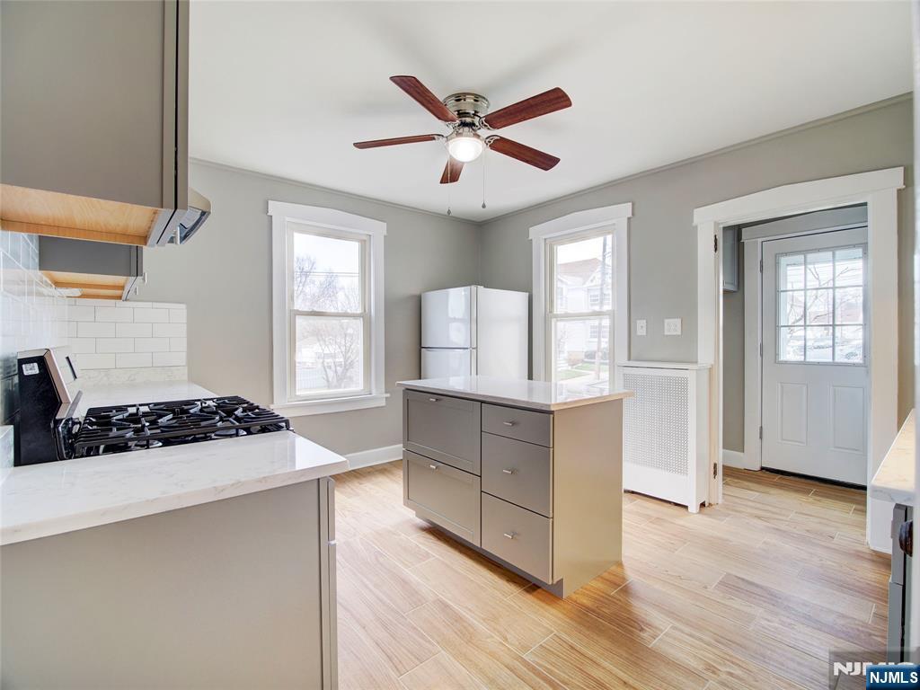 140 Westervelt Avenue Hawthorne, NJ 07506 - Photo 8 of 36 a kitchen with stainless steel appliances a stove a sink a window and a refrigerator
