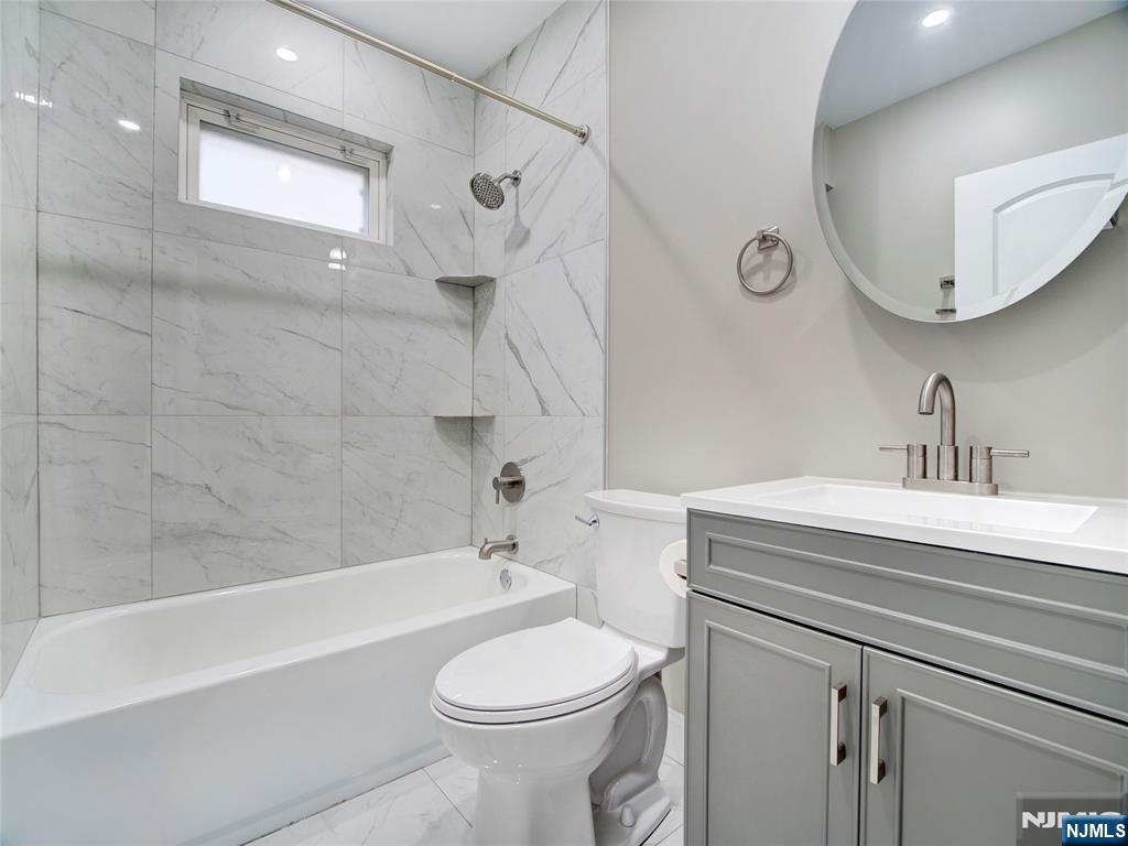 140 Westervelt Avenue Hawthorne, NJ 07506 - Photo 10 of 36 a bathroom with a sink a toilet and shower