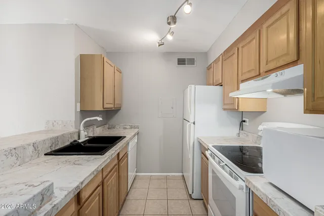 a kitchen with a sink stove and refrigerator
