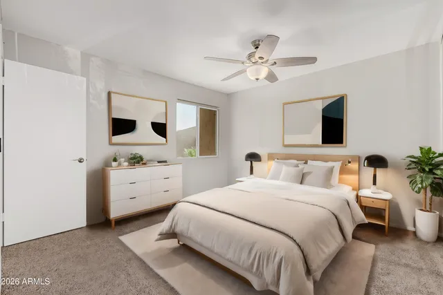 a bedroom with a large bed and a flat screen tv