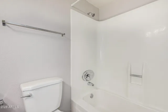 a bathroom with a bathtub and a toilet