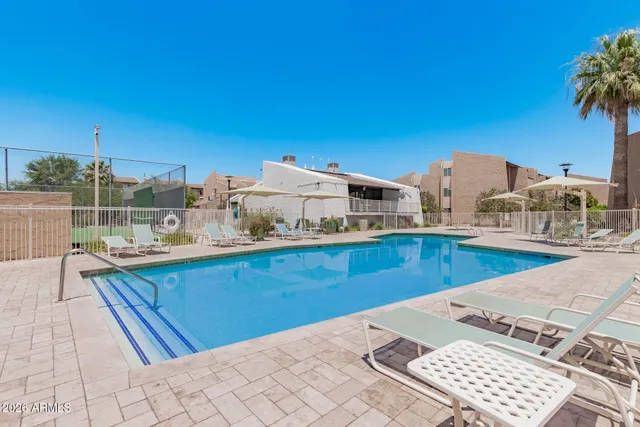 a view of a swimming pool with a lounge chair