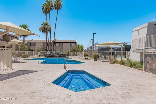a view of swimming pool with palm trees