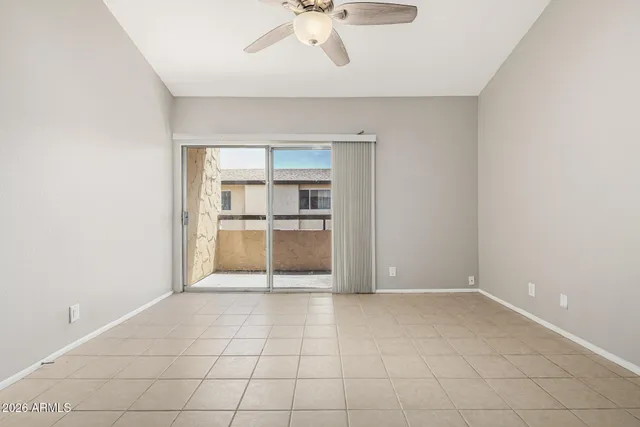 an empty room with a empty space and chandelier fan