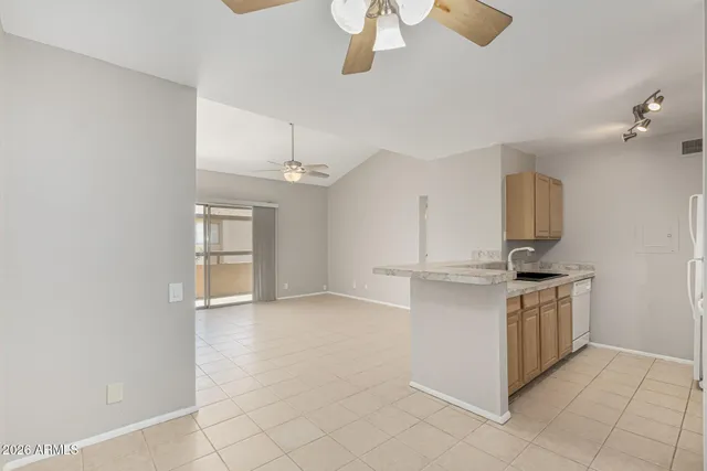 a kitchen with kitchen island granite countertop a stove and a sink