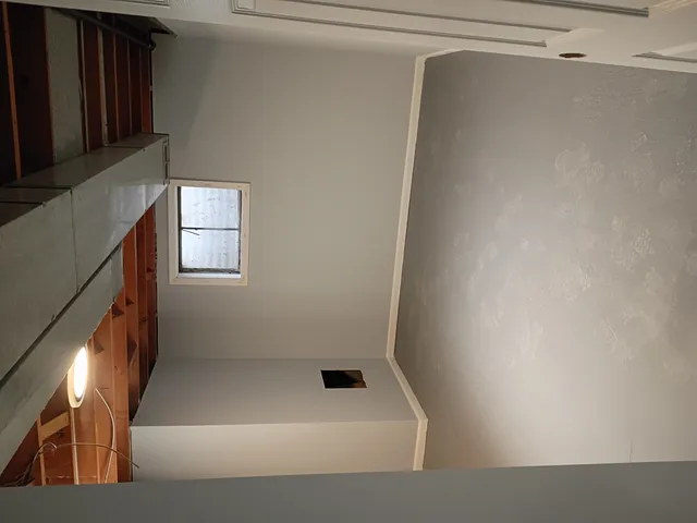 a living room with a bed and a window