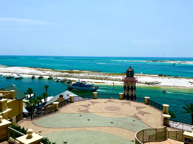 a living room with couches and kitchen view with wooden floor