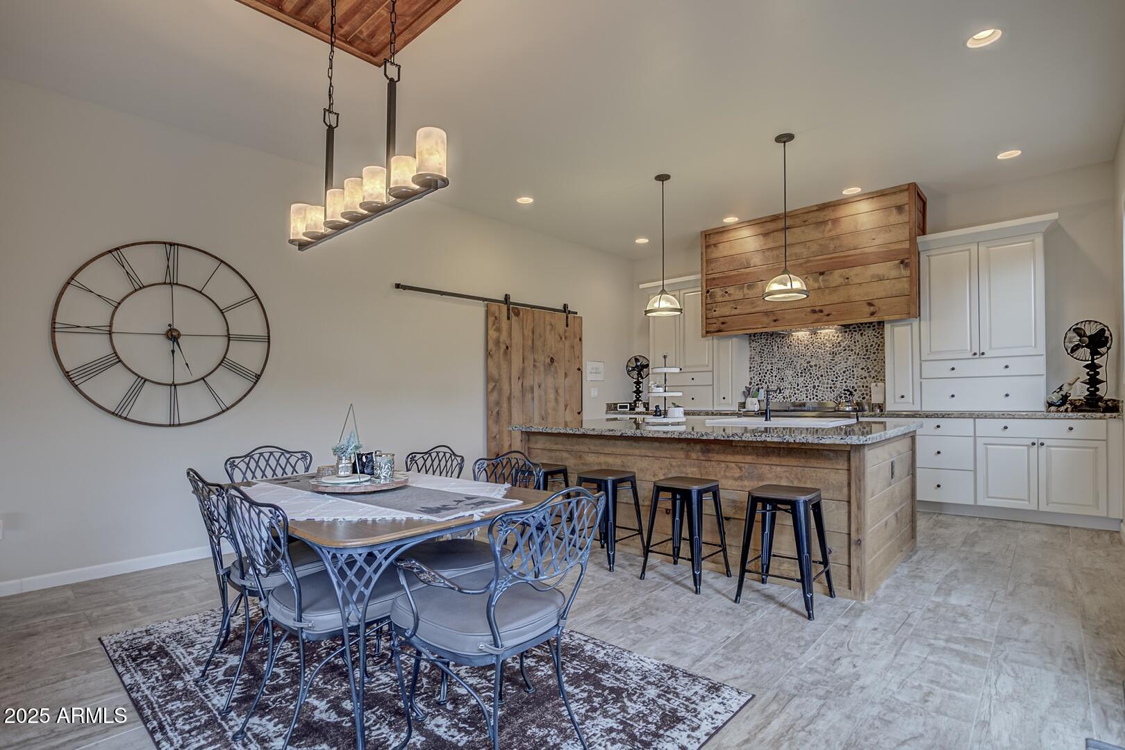 5076 Juniper Loop Pine, AZ 85544 - Photo 11 of 68 a open kitchen with a table and chairs in it