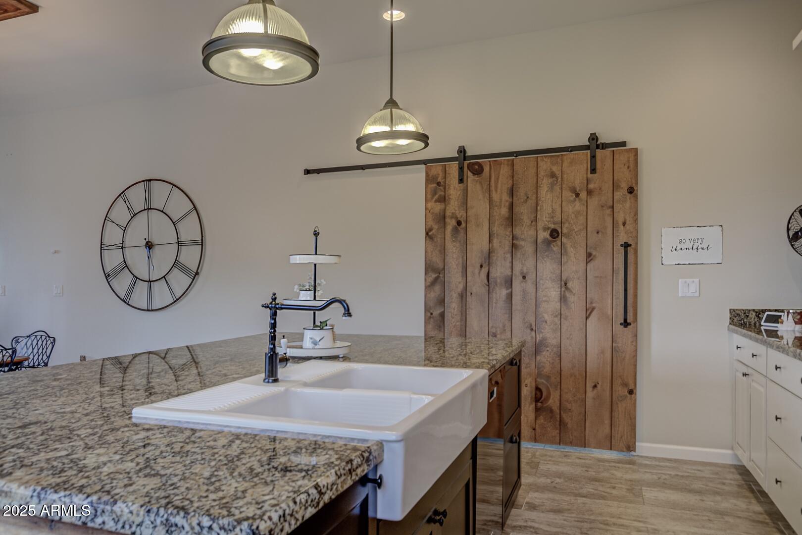 5076 Juniper Loop Pine, AZ 85544 - Photo 14 of 68 a kitchen with stainless steel appliances granite countertop a sink dishwasher and a refrigerator with wooden floor