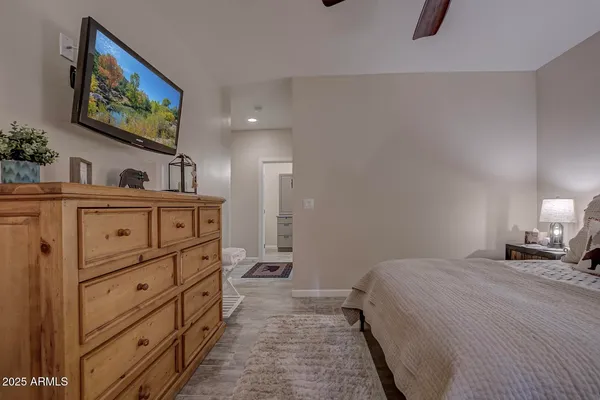 a bedroom with a bed and a chandelier