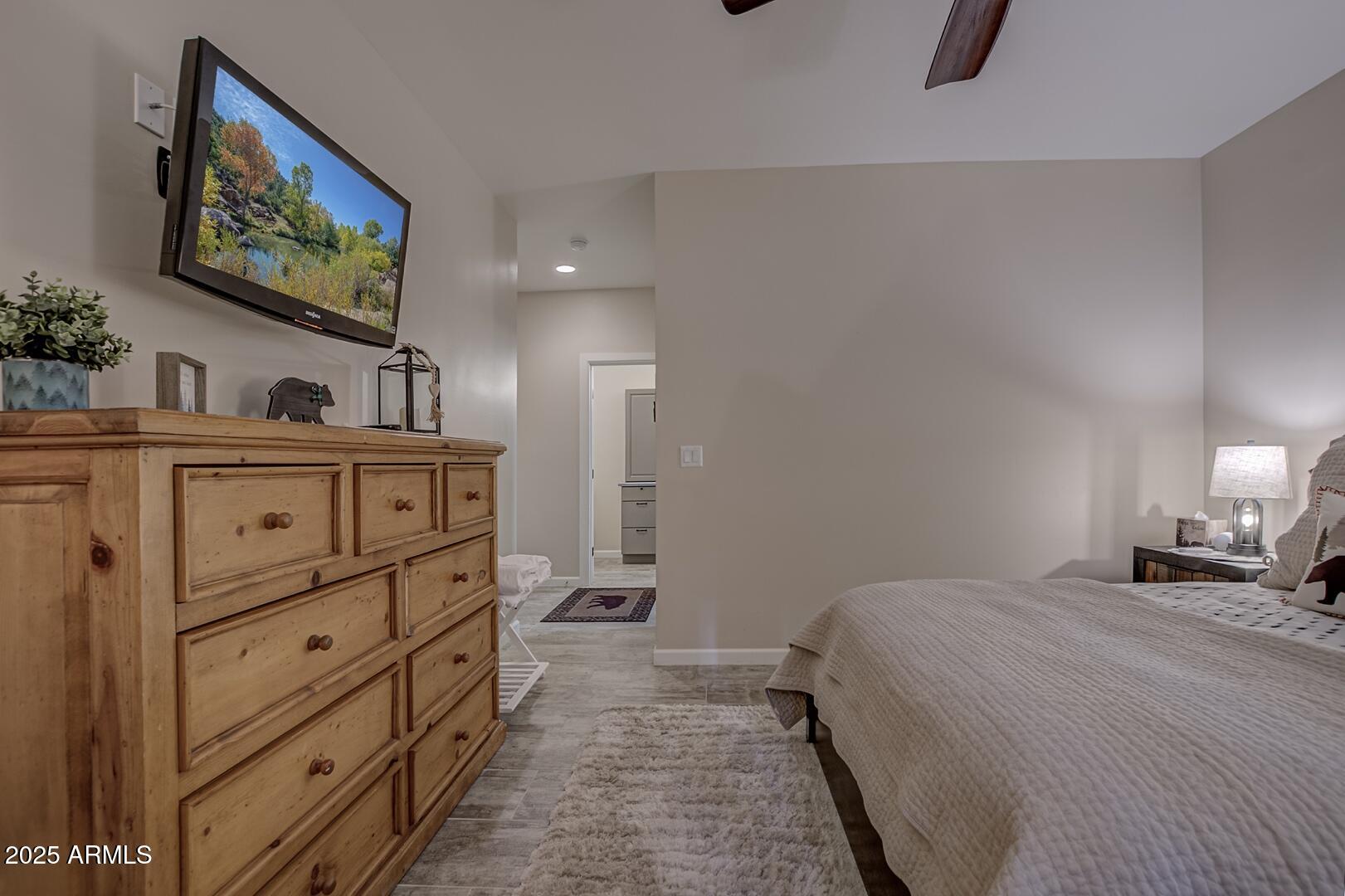 5076 Juniper Loop Pine, AZ 85544 - Photo 20 of 68 a bedroom with a bed and a flat screen tv