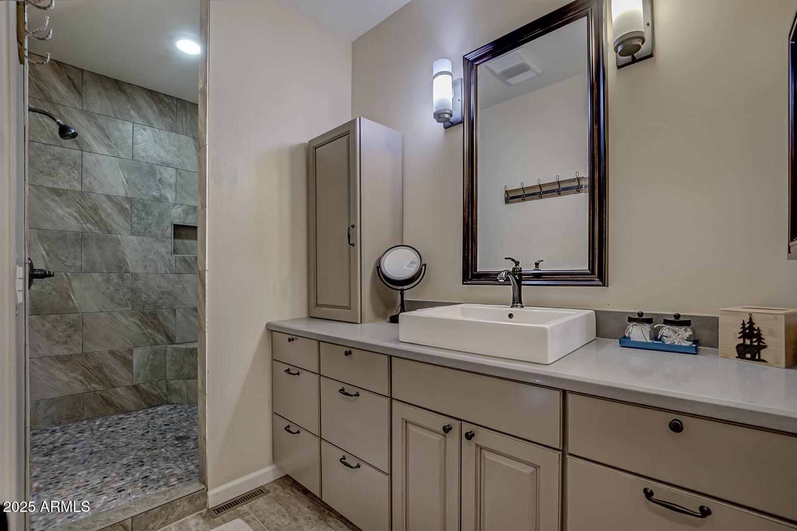 5076 Juniper Loop Pine, AZ 85544 - Photo 22 of 68 a bathroom with a sink and a mirror with shower