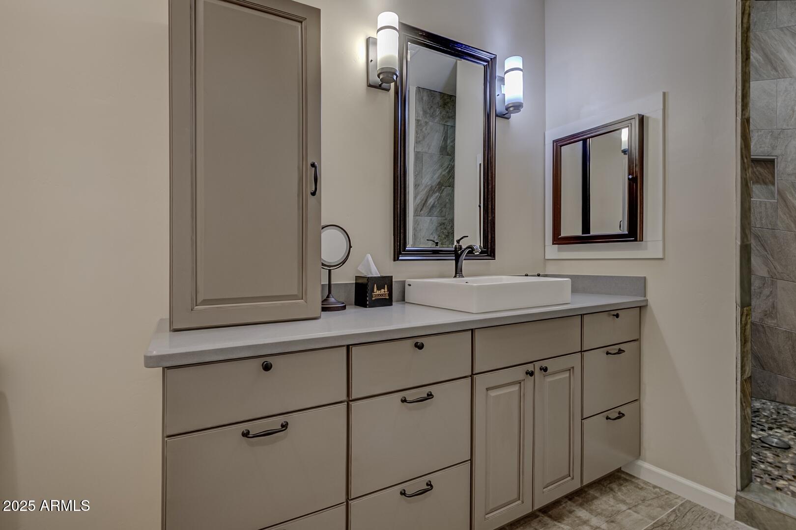 5076 Juniper Loop Pine, AZ 85544 - Photo 26 of 68 a bathroom with a double vanity sink mirror and