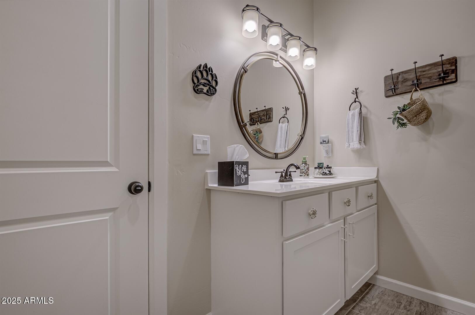 5076 Juniper Loop Pine, AZ 85544 - Photo 38 of 68 a bathroom with a sink and a mirror