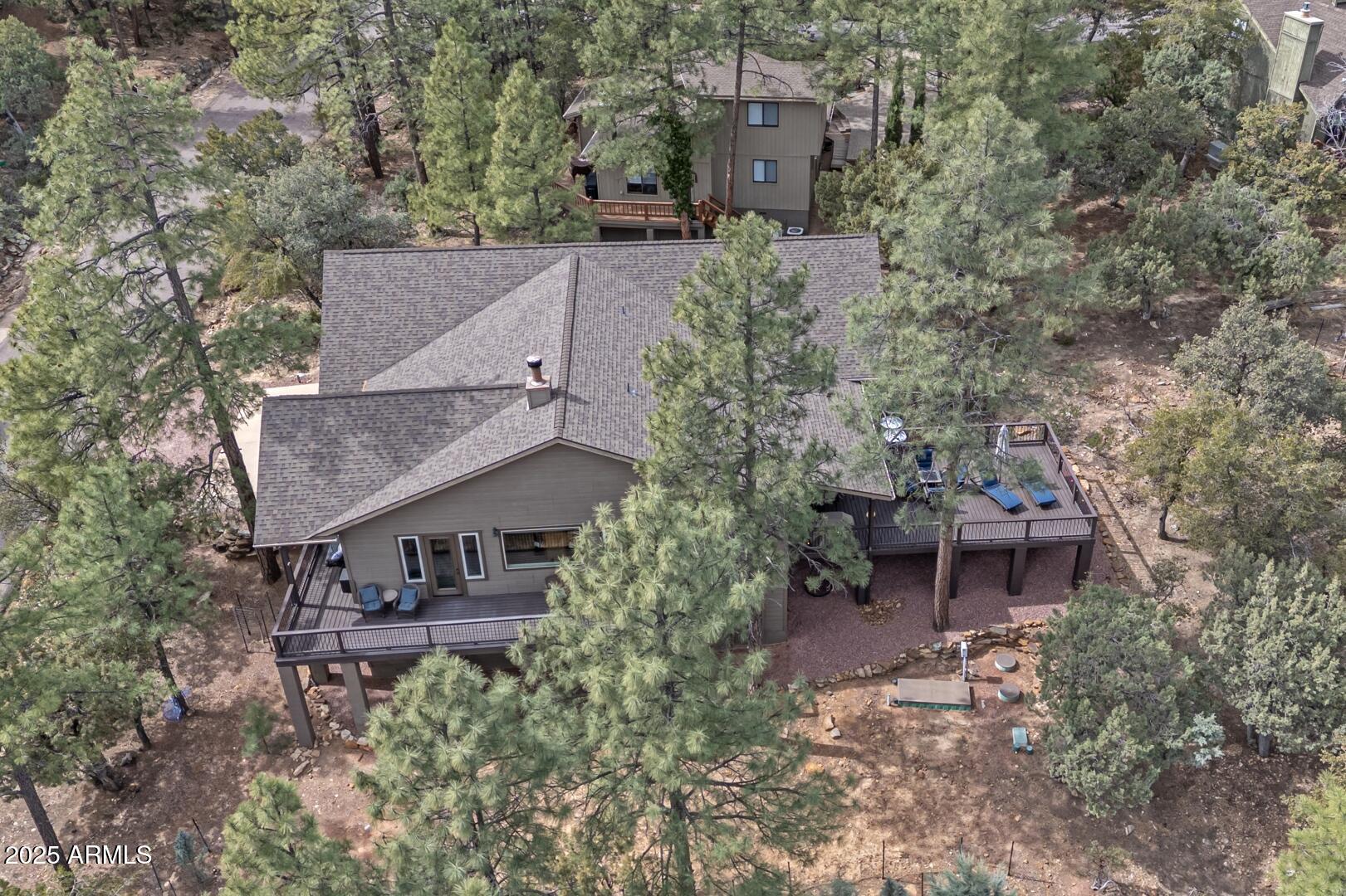 5076 Juniper Loop Pine, AZ 85544 - Photo 46 of 68 an aerial view of a house with a yard fire pit and outdoor seating