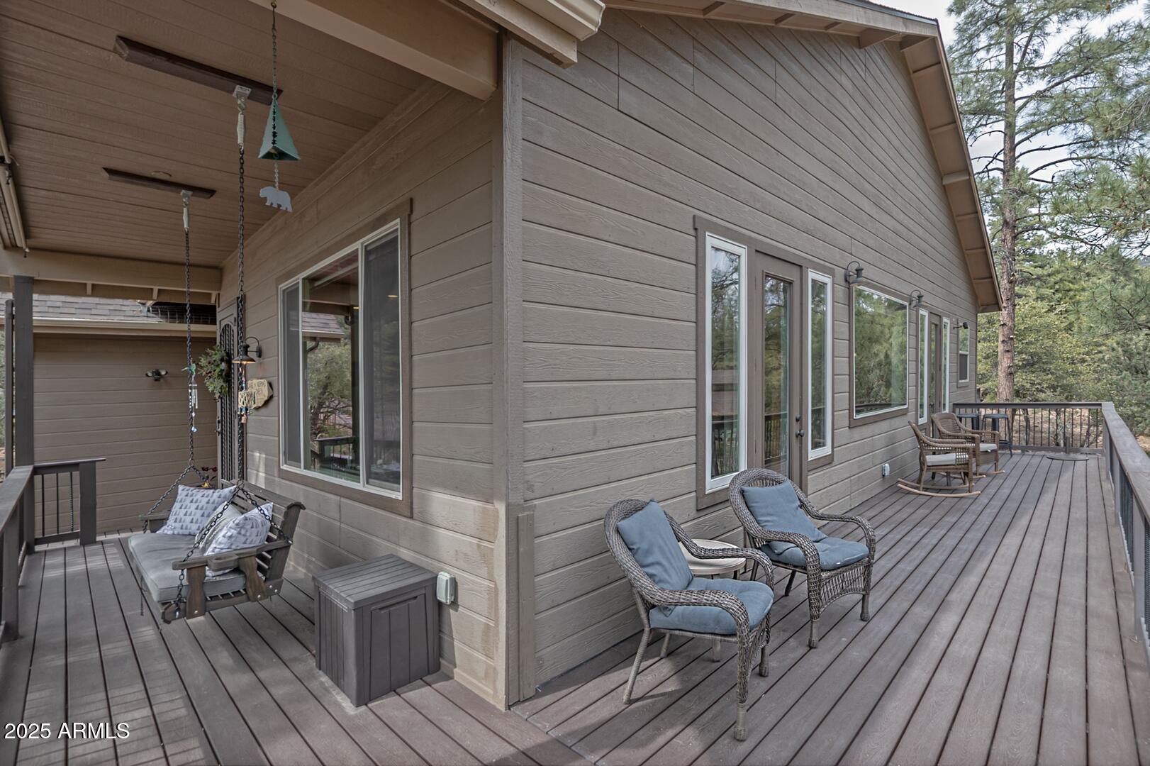 5076 Juniper Loop Pine, AZ 85544 - Photo 56 of 68 a view of deck with table and chairs wooden floor and fence