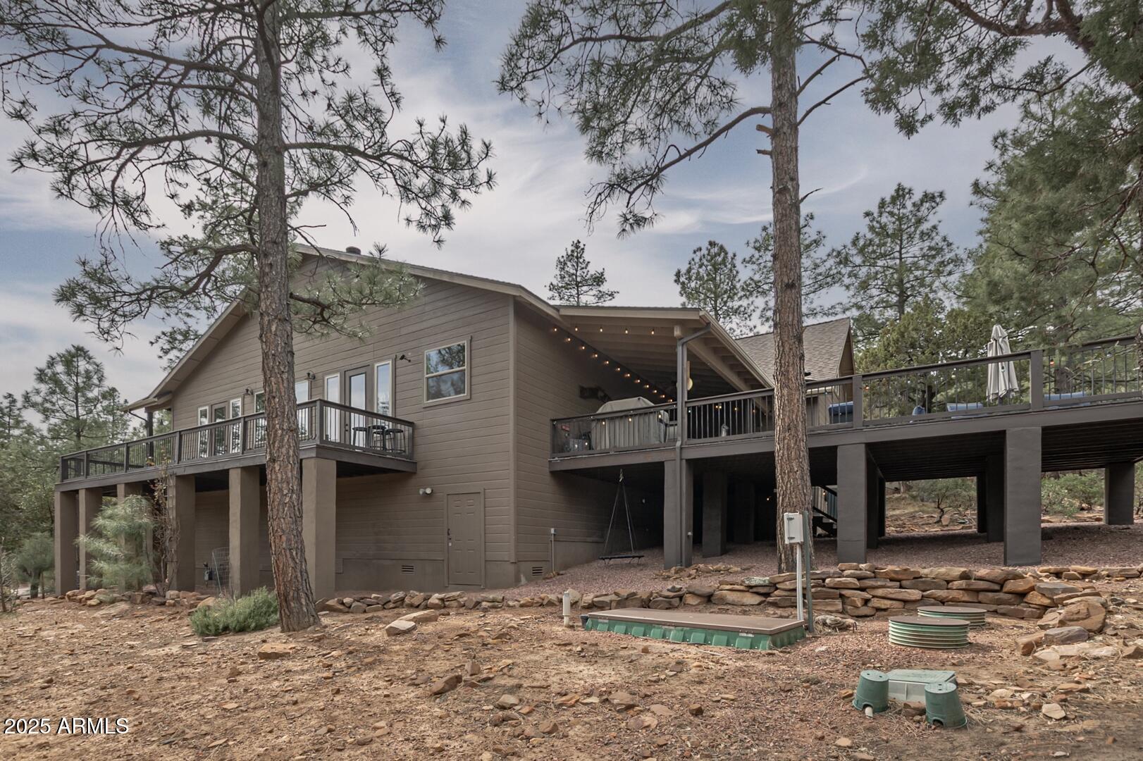5076 Juniper Loop Pine, AZ 85544 - Photo 57 of 68 a front view of a house with trees