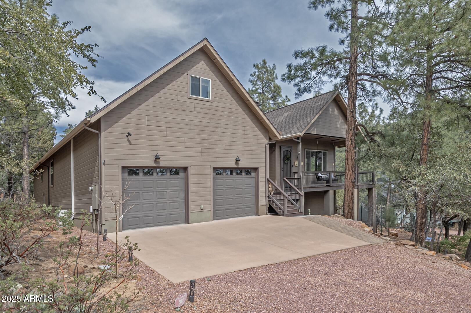 5076 Juniper Loop Pine, AZ 85544 - Photo 58 of 68 a front view of house with yard and trees in the background