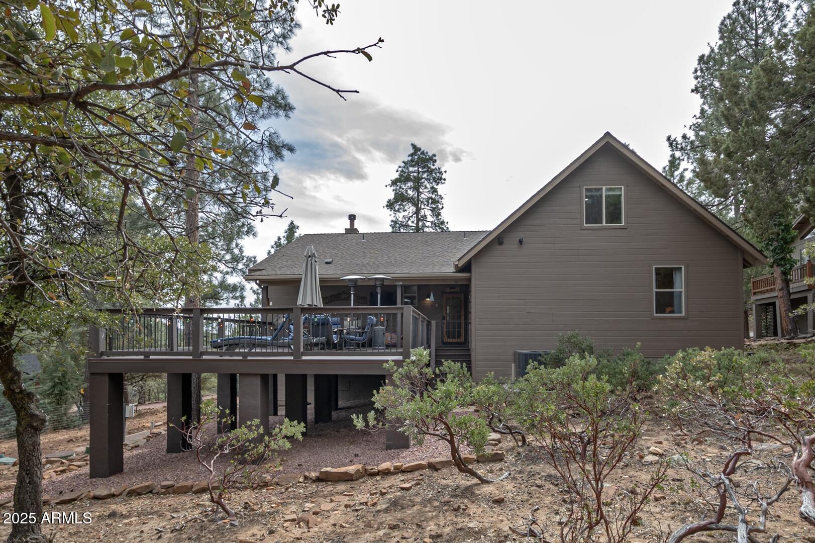 5076 Juniper Loop Pine, AZ 85544 - Photo 60 of 68 a front view of a house with plants and trees