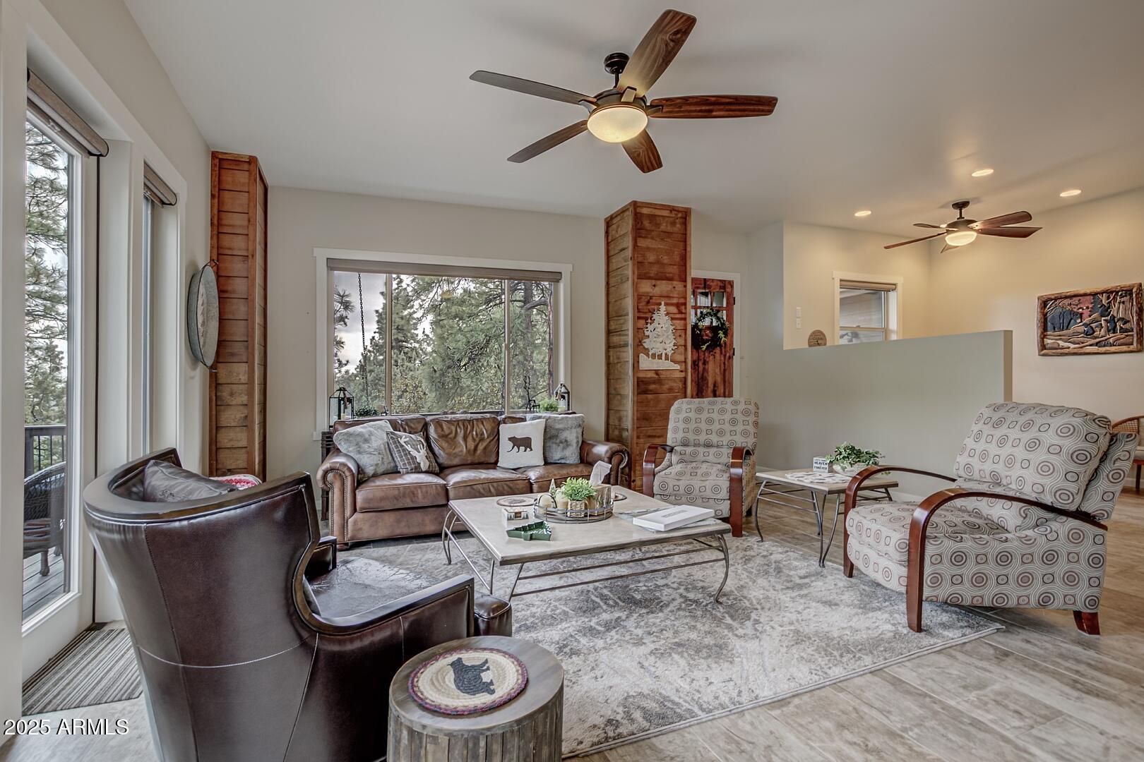 5076 Juniper Loop Pine, AZ 85544 - Photo 6 of 68 a living room with furniture and a large window