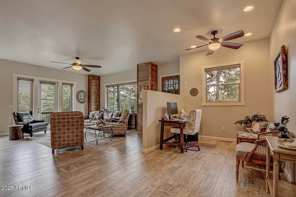 a living room with furniture and wooden floor