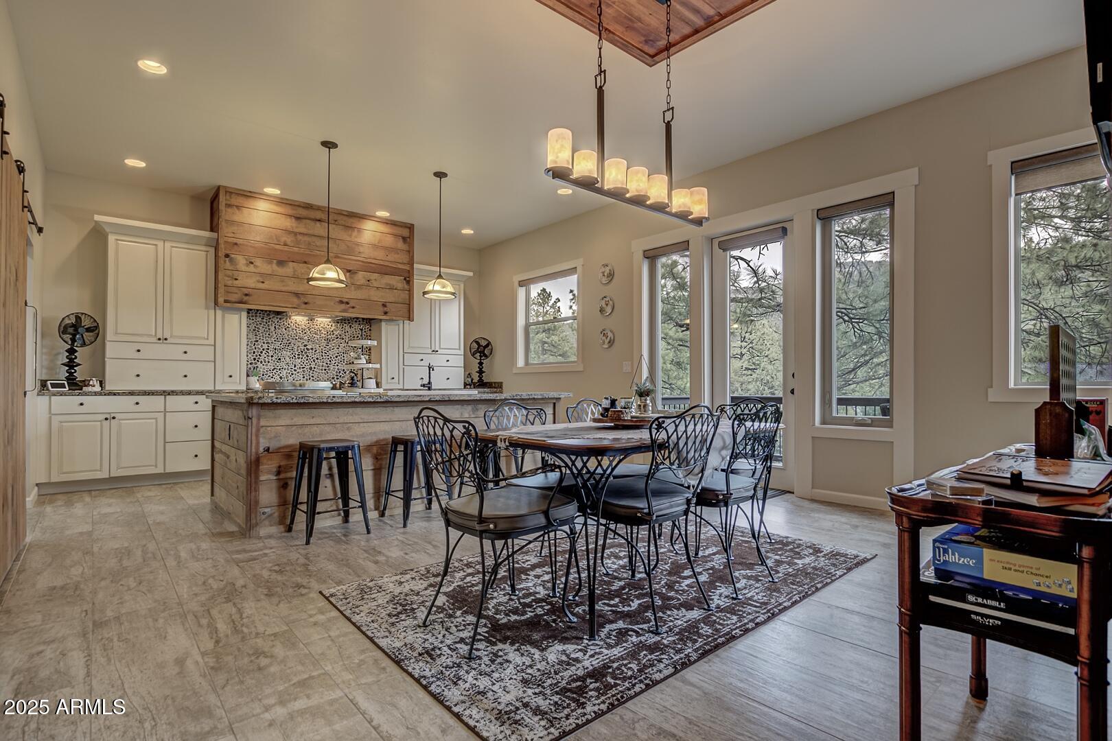 5076 Juniper Loop Pine, AZ 85544 - Photo 10 of 68 a view of a dining room with furniture window and wooden floor
