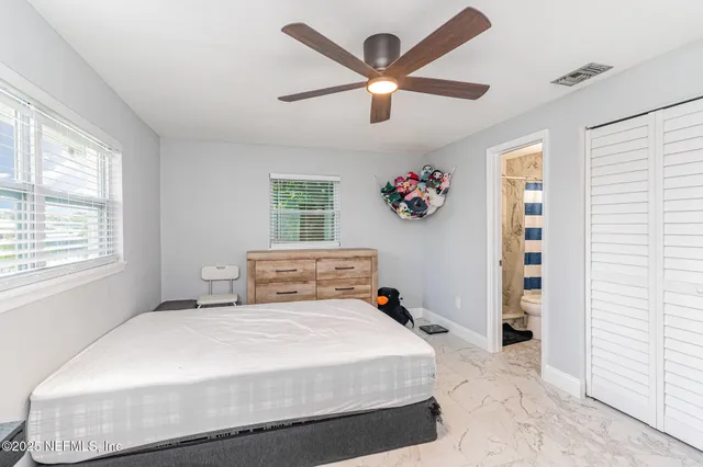 a bedroom with a large bed and a window