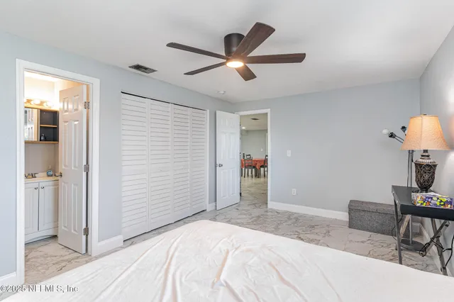 a bedroom with a bed and a desk