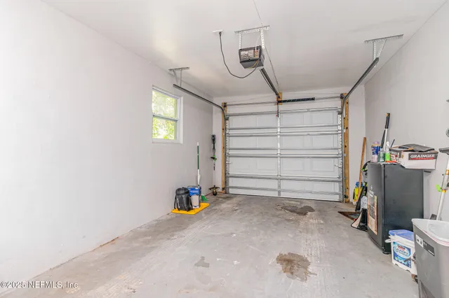 a view of a yard with wooden fence