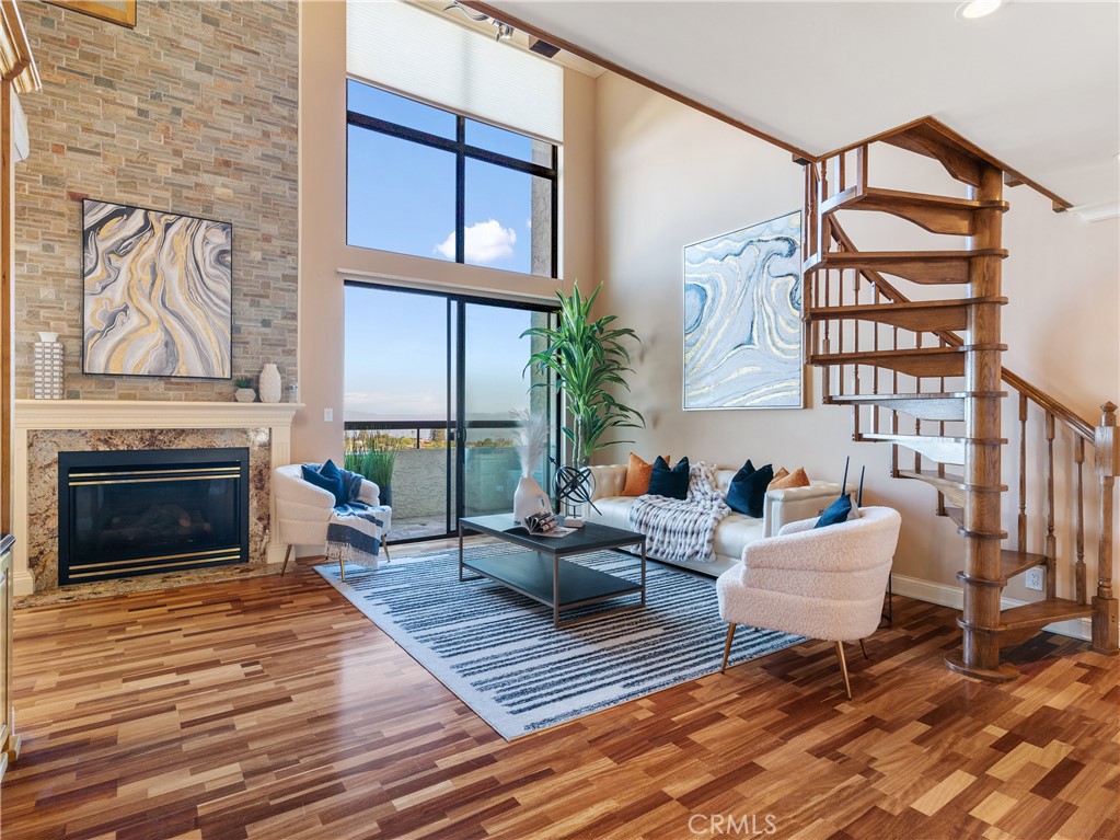 5987 Peacock Ridge Road, Unit 112 Rancho Palos Verdes, CA 90275 - Photo 1 of 1 a living room with furniture a fireplace and a floor to ceiling window