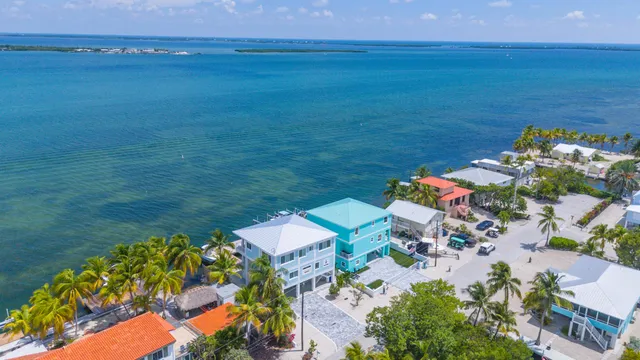 an aerial view of a house with a ocean view
