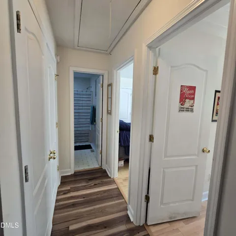 a view of a hallway with wooden floor and entryway
