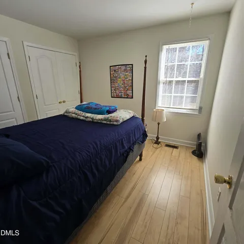 a view of a patio with table and chairs potted plants and covered with wooden fence