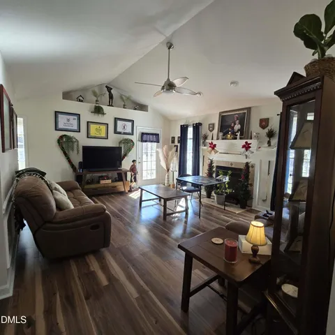 a living room with furniture and a wooden floor