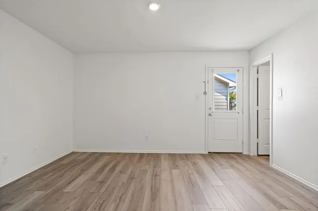 a view of an empty room and wooden floor