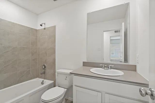a bathroom with a sink toilet tub and shower
