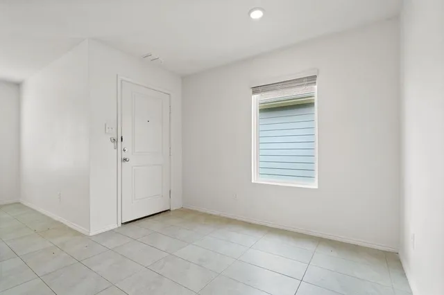 an empty room with a empty space and windows