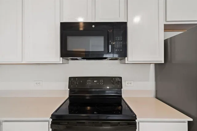 a kitchen with a stove and a microwave