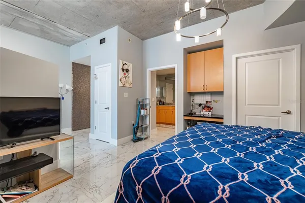 a bathroom with a granite countertop sink mirror vanity bathtub and toilet