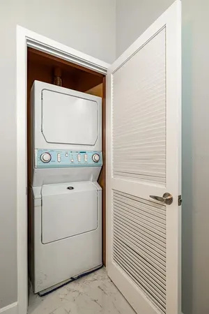 a view of a balcony with two chairs and a table