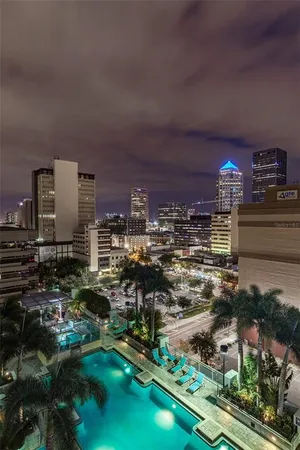 a living room with furniture and large windows