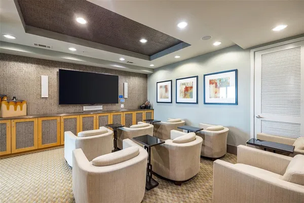 a spacious bedroom with furniture and a large window