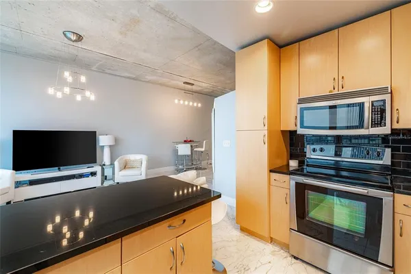 a view of kitchen with furniture and flat screen tv