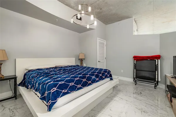 a bedroom with a bed and a flat screen tv