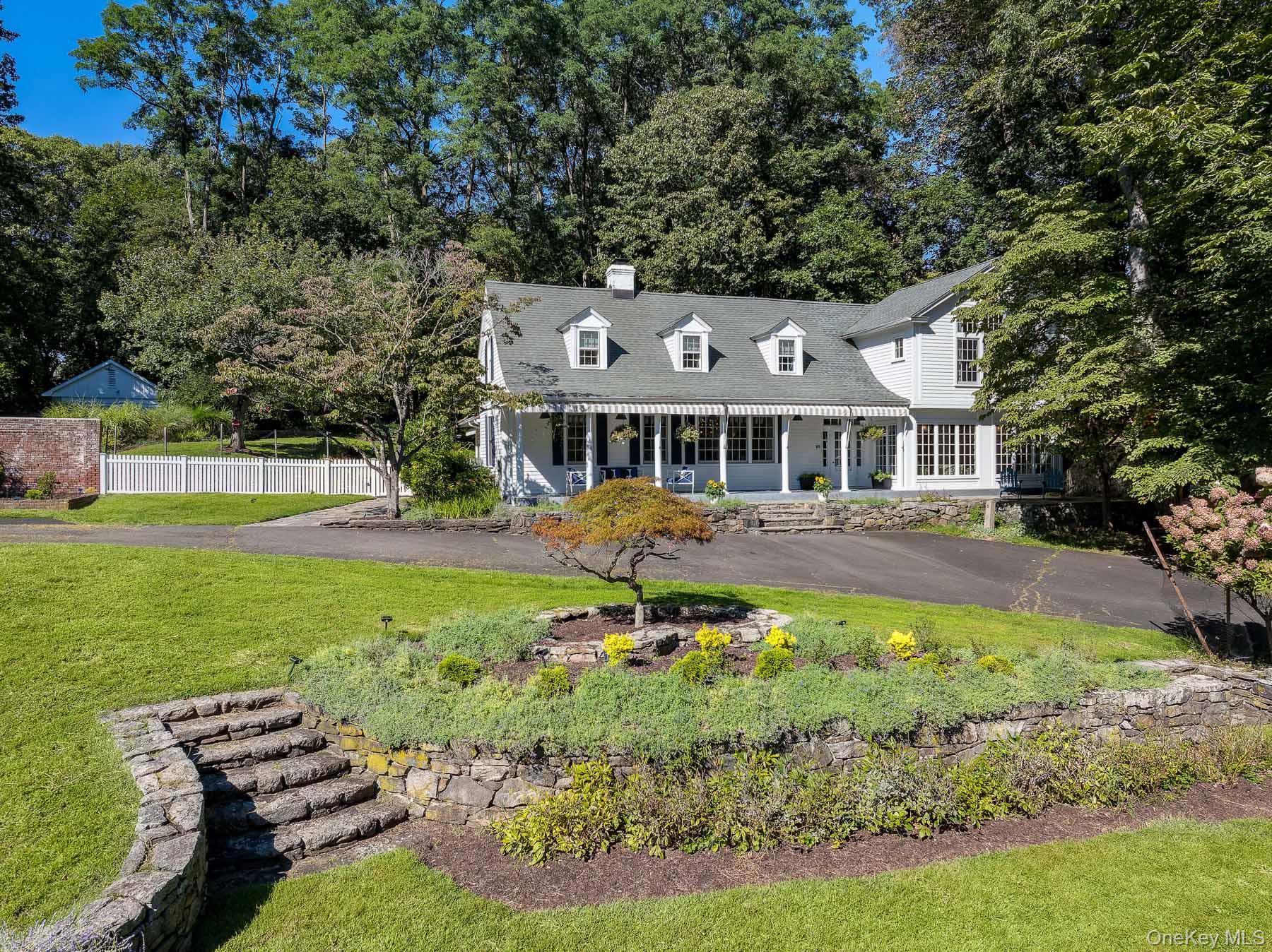 a front view of a house with swimming pool patio and garden