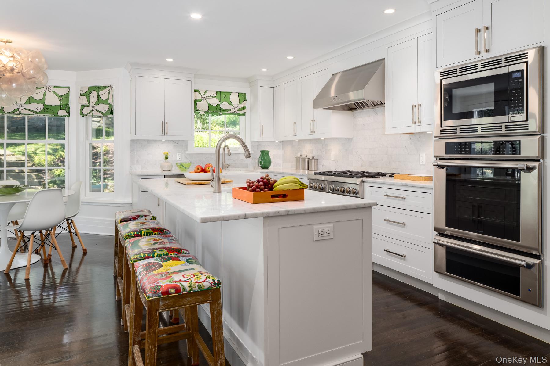 71 Havemeyer Road Irvington, NY 10533 - Photo 11 of 38 a kitchen with stainless steel appliances granite countertop a stove a sink and a microwave