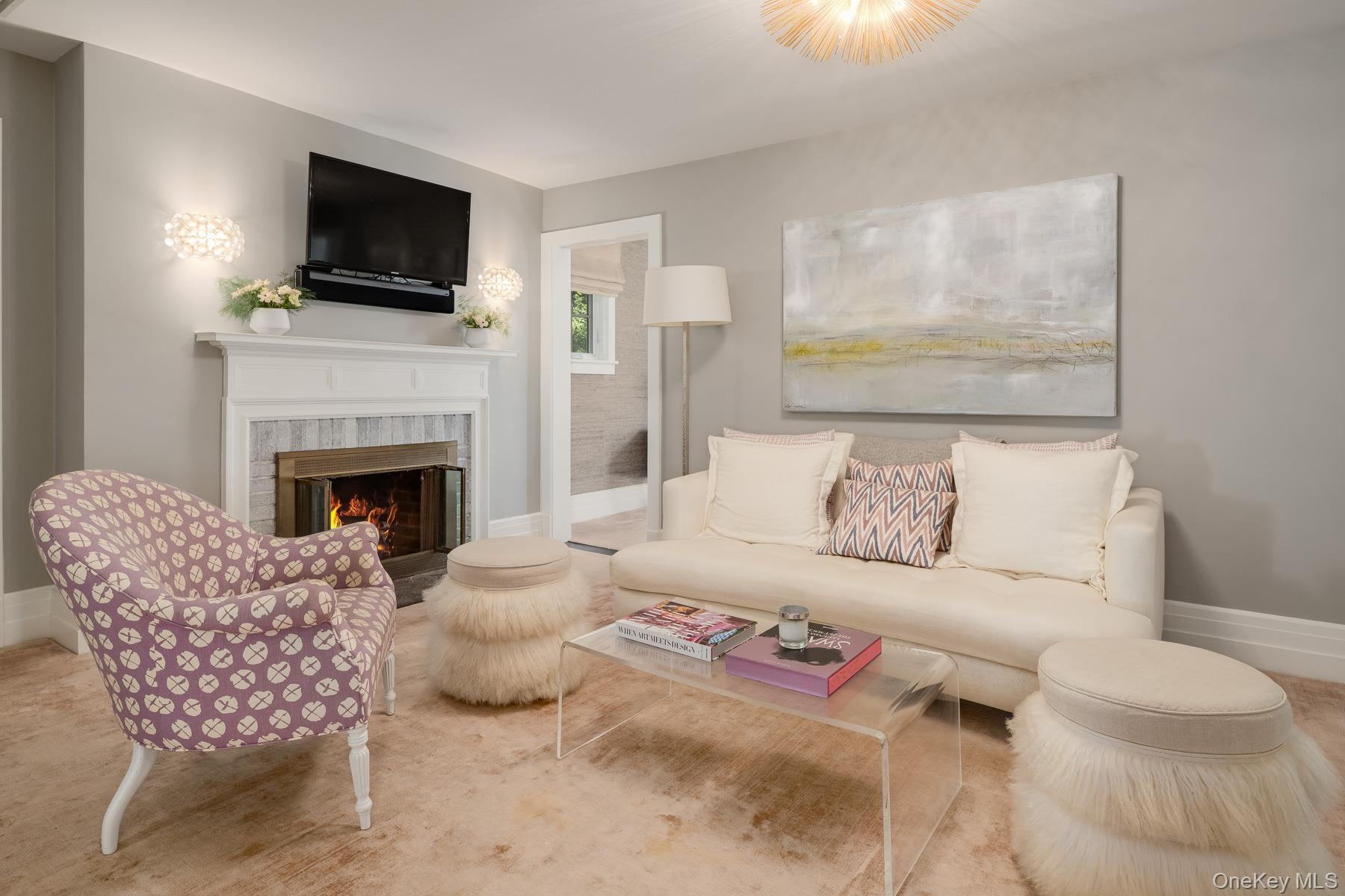 71 Havemeyer Road Irvington, NY 10533 - Photo 21 of 38 a living room with furniture a flat screen tv and a fireplace