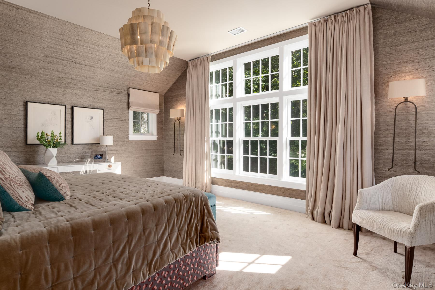 71 Havemeyer Road Irvington, NY 10533 - Photo 22 of 38 a spacious bedroom with a bed and a large window