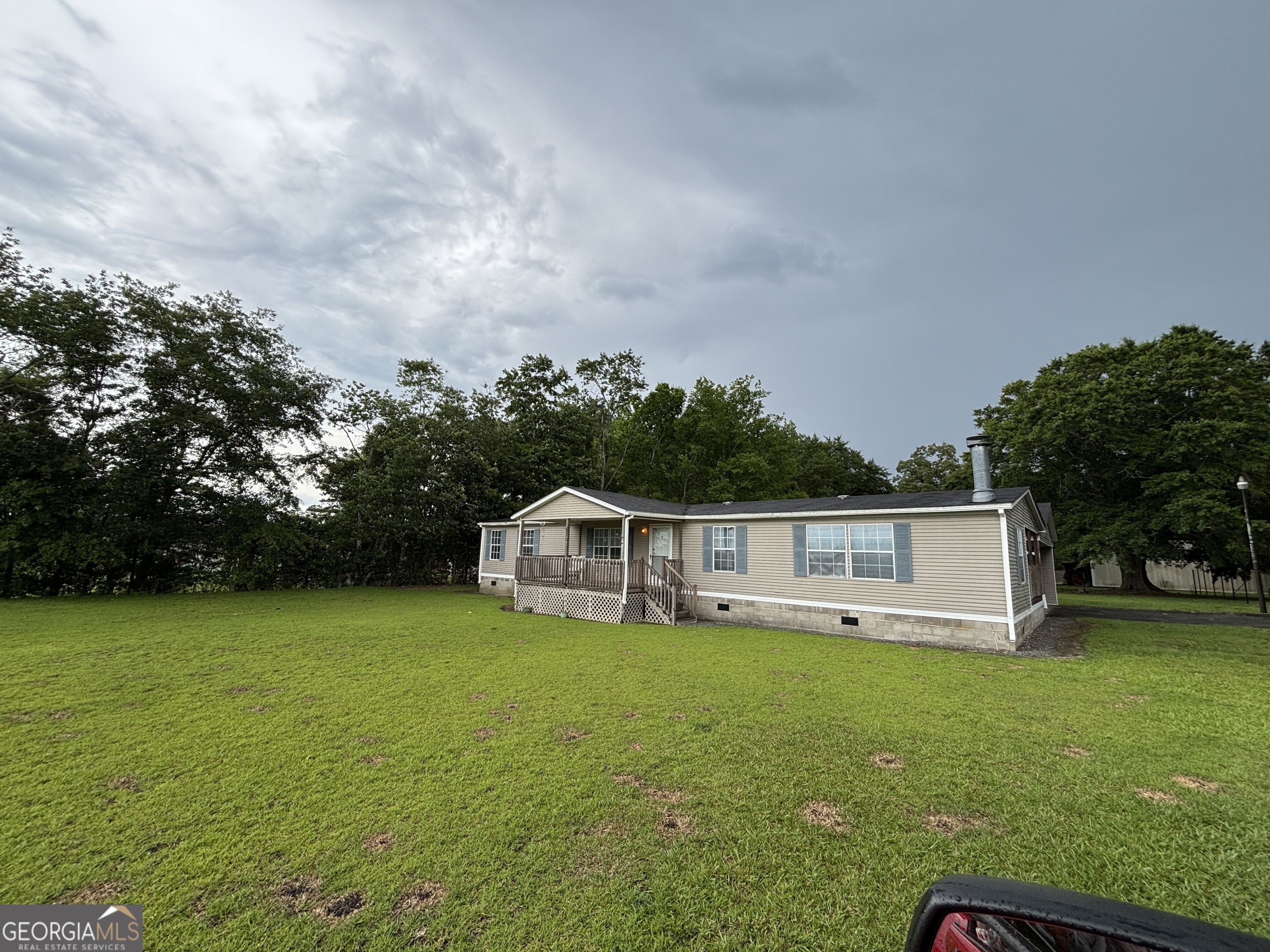 a view of a house with yard and sitting area