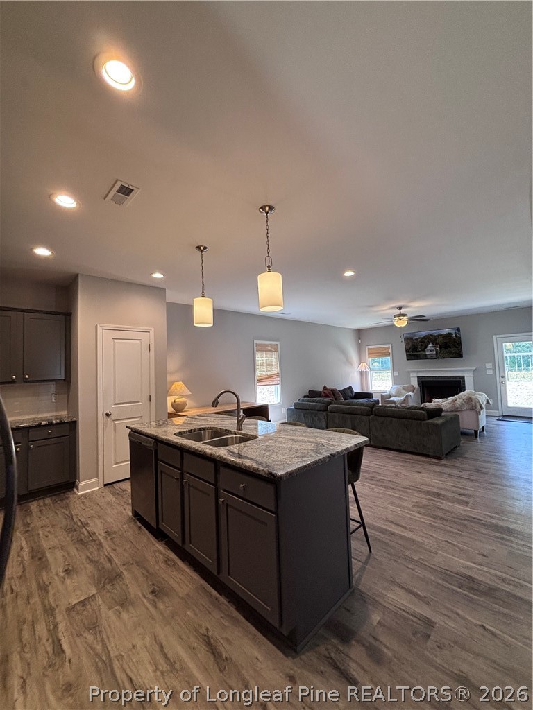 7720 Rufus Johnson Road Fayetteville, NC 28306 - Photo 22 of 50 a kitchen with stainless steel appliances granite countertop a sink a stove and a wooden floors